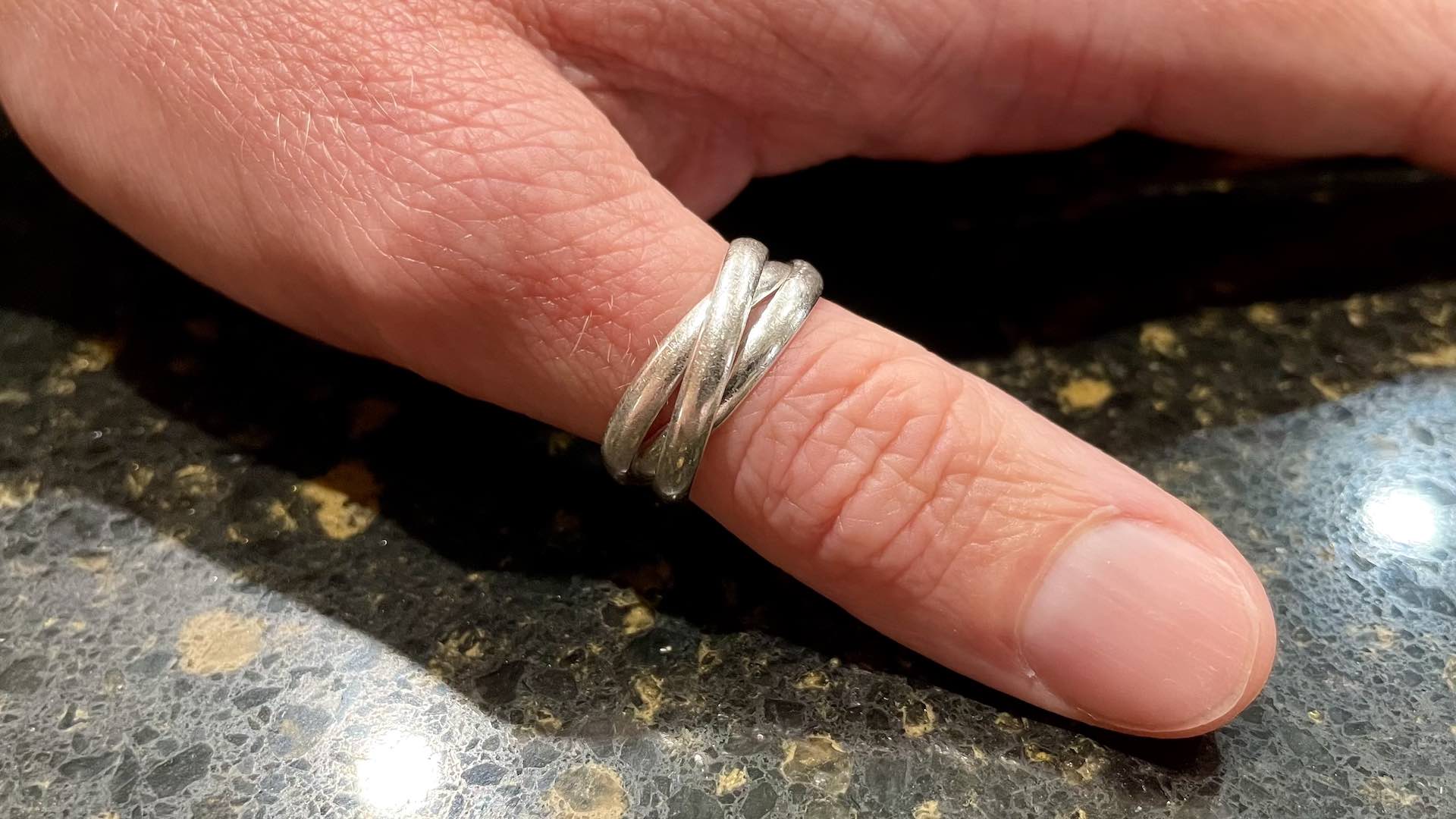 The little three band silver ring on Jenni's thumb since she was a teenager—my inspiration!